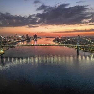 Ambassador Bridge Detroit skyline sunrise fine art print with river reflections and warm morning light